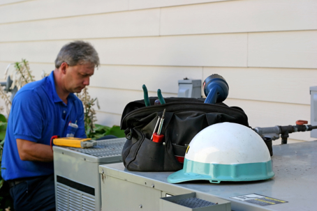 man servicing AC